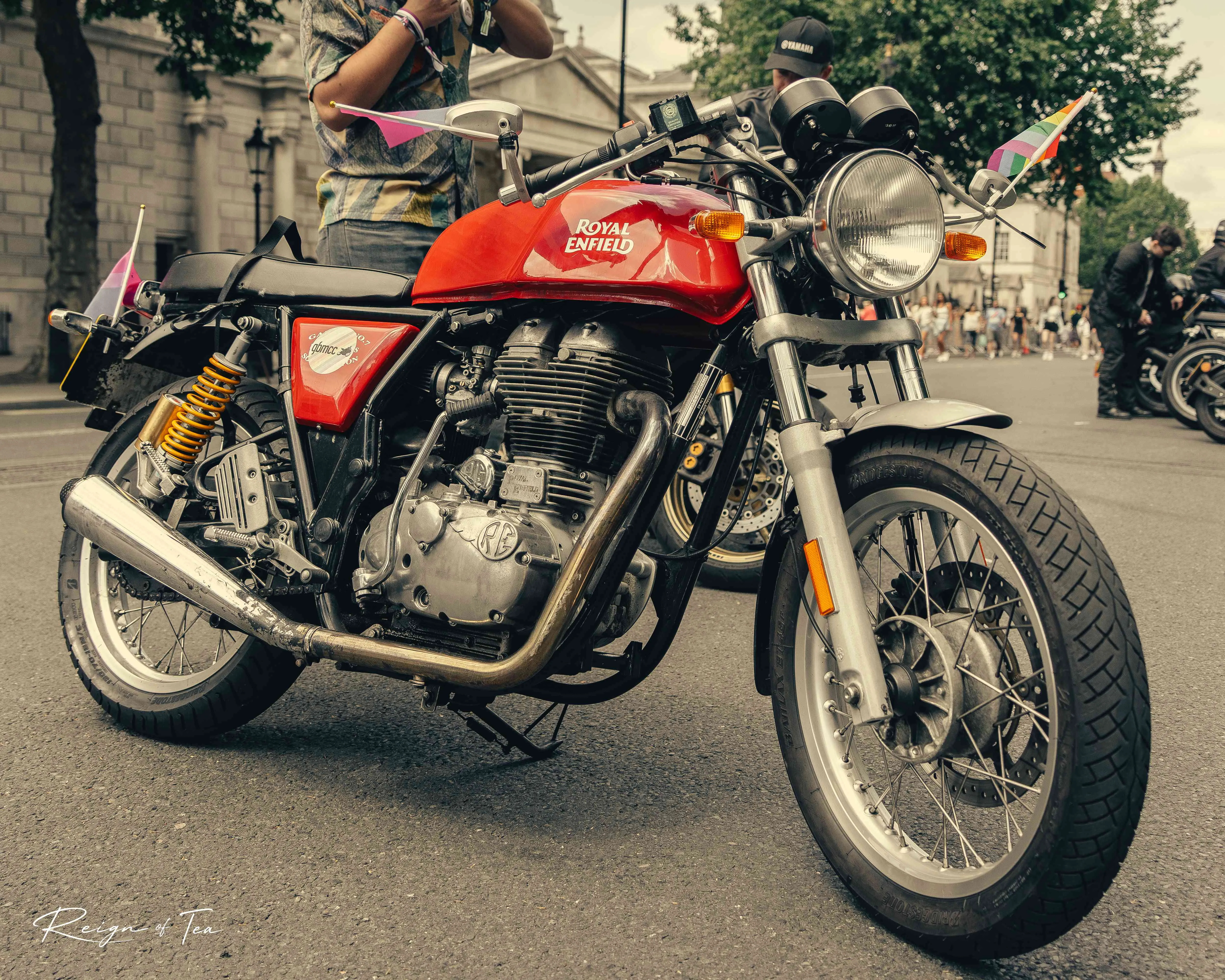 Red Royal Enfield motorcycle dressed in Pride flags at London Pride